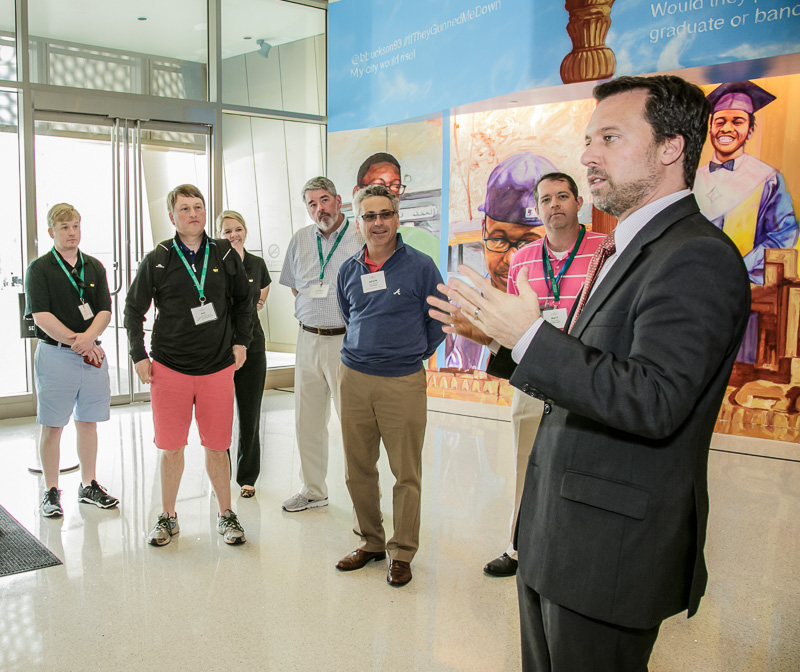 adults listening to a director or curator