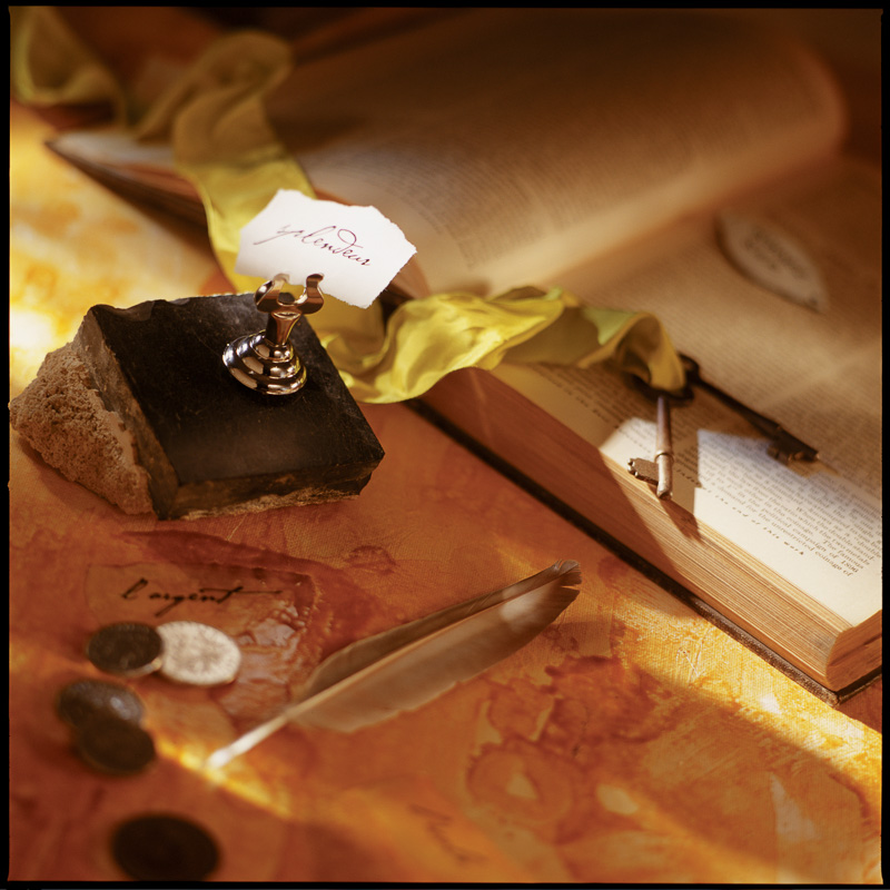 book with keys, feather and table placeholder